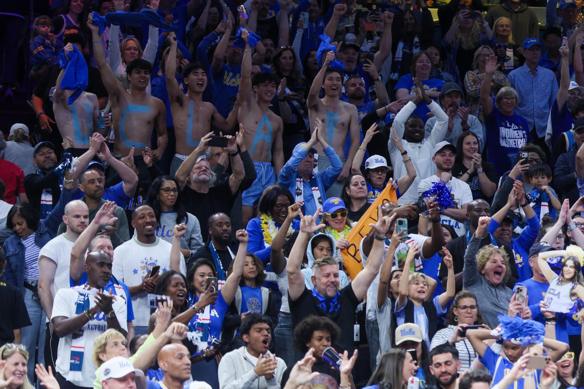 UCLA fans celebrate after the Bruins beat Texas during a Final Four semifinal at Mortgage Matchup Center on Friday.