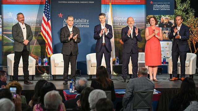 California gubernatorial candidates, from left, Chad Bianco, Xavier Becerra, Matt Mahan, Steve Hilton, Katie Porter, and Antonio Villaraigosa stand on stage at the conclusion of a forum hosted by the Western Growers Association at Fresno State on Wednesday, April 1, 2026.