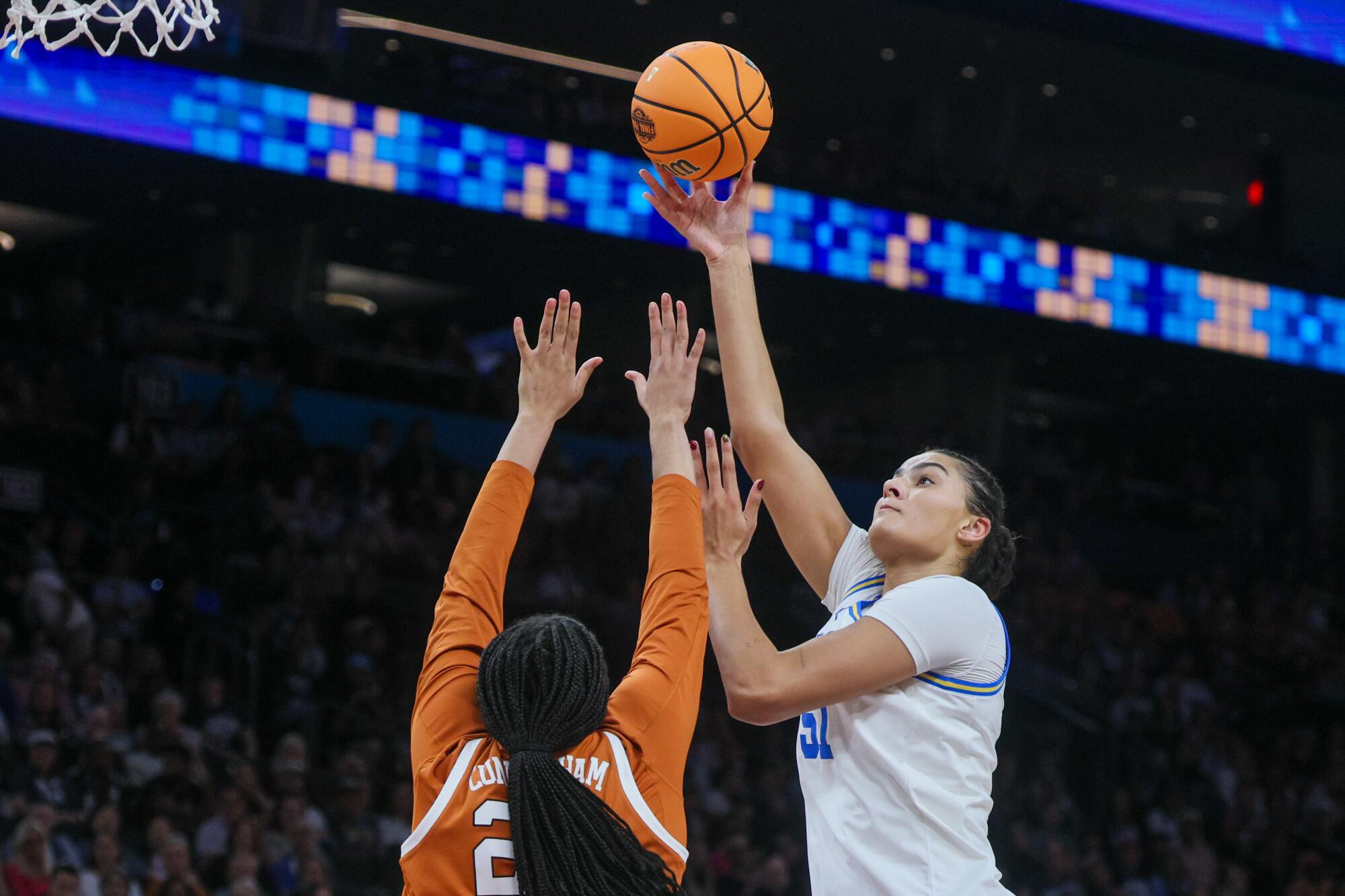 UCLA center Lauren Betts shoots over Texas forward Breya Cunningham during their Final Four matchup Friday in Phoenix.
