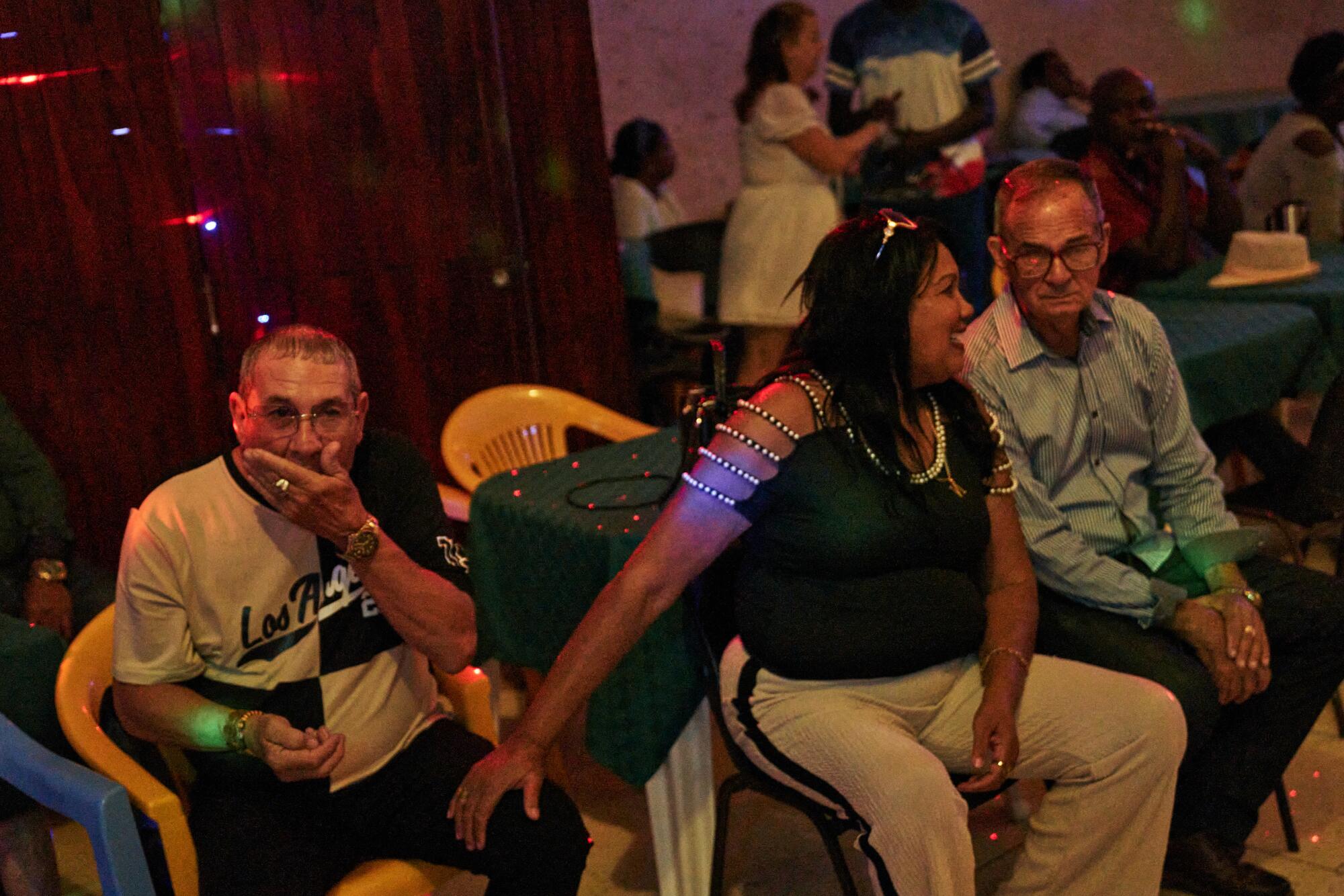 Nurys Núñez Arellano, gently touches her partner, German Fernández Miranda. 