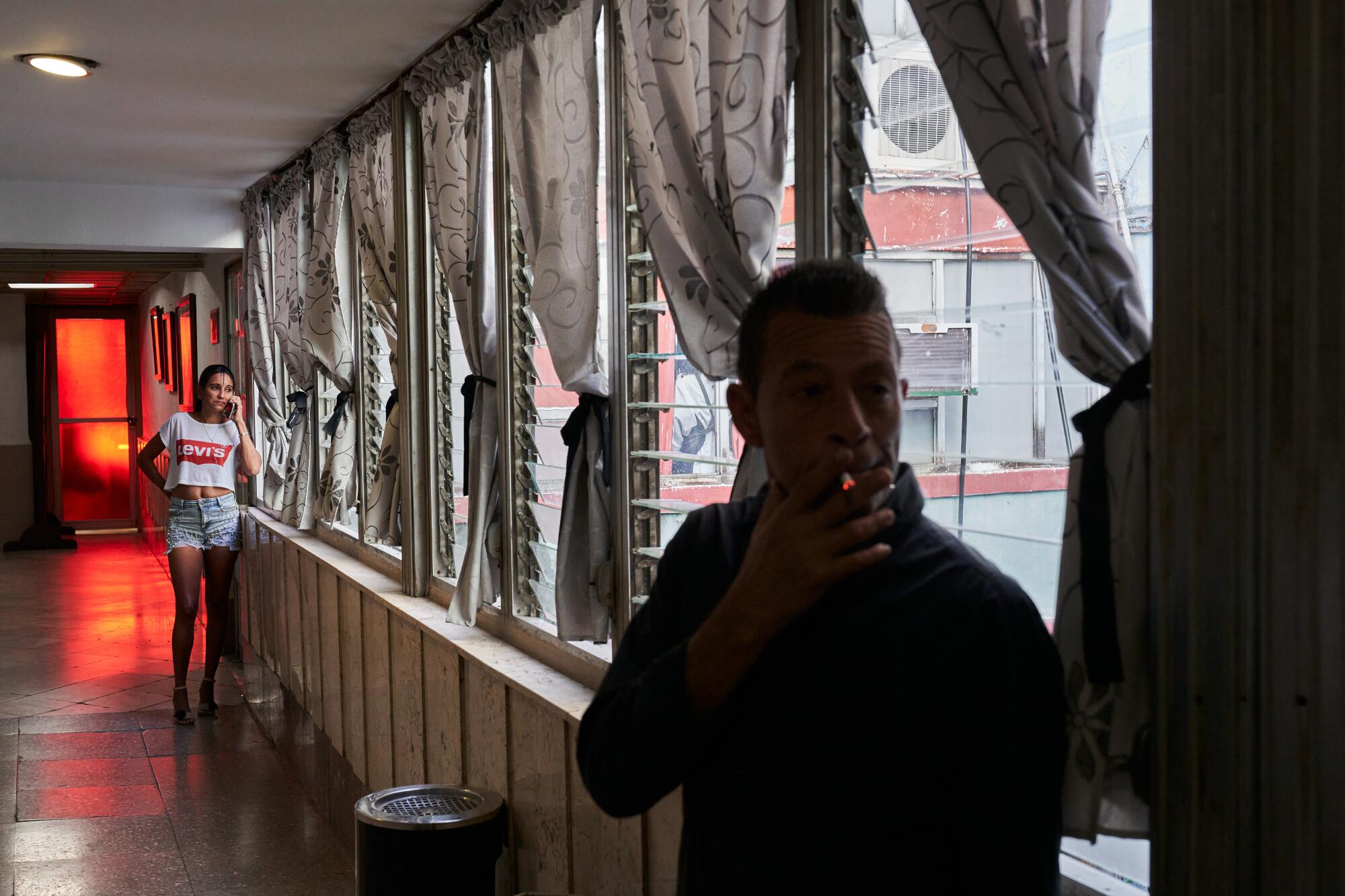 Maurin Piedra Rodriguez, 52, speaks on the phone in the smoking area