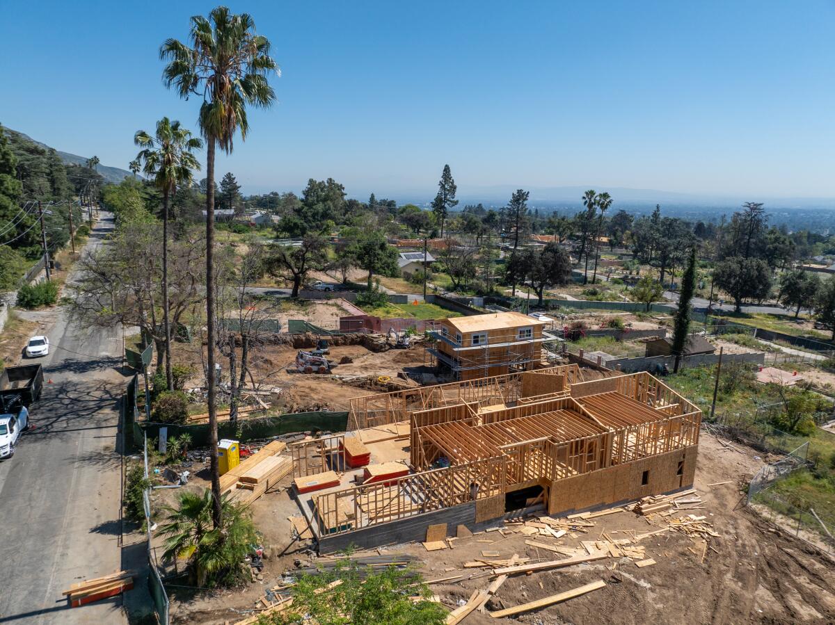 An aerial view of construction crews rebuilding homes that were destroyed