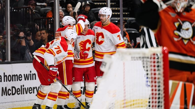 Calgary Flames center Ryan Strome, third from left, is greeted...