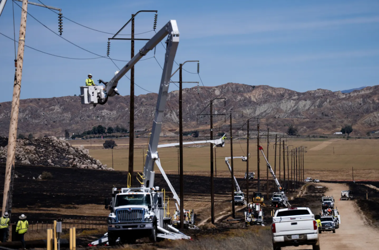 Utility crews work to restore power lines in an area burned by the Springs Fire in Moreno Valley, Calif., Saturday, April 4, 2026.
