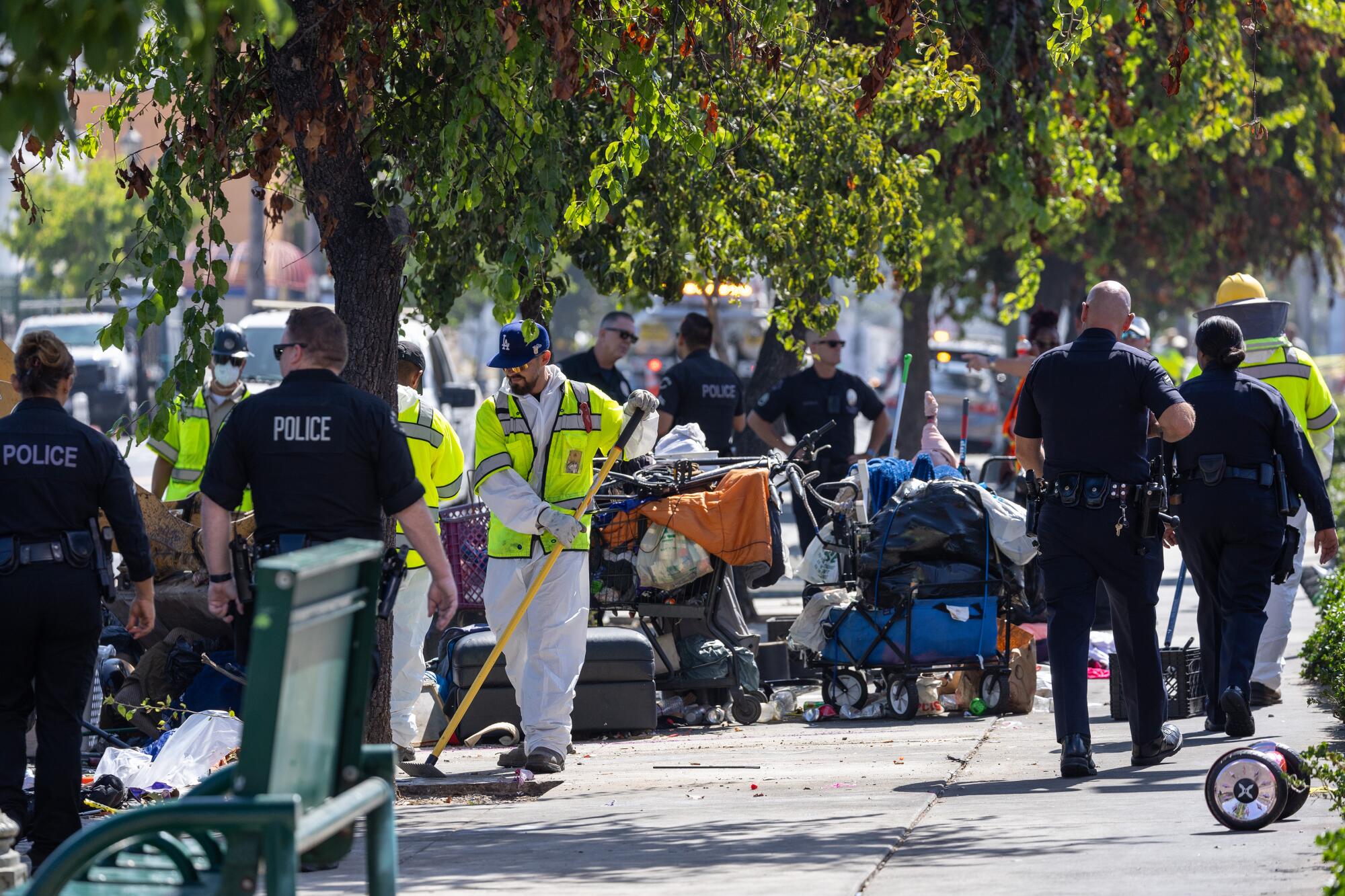 Los Angeles sanitation workers clean a homeless encampment along Hollywood Boulevard in 2024.