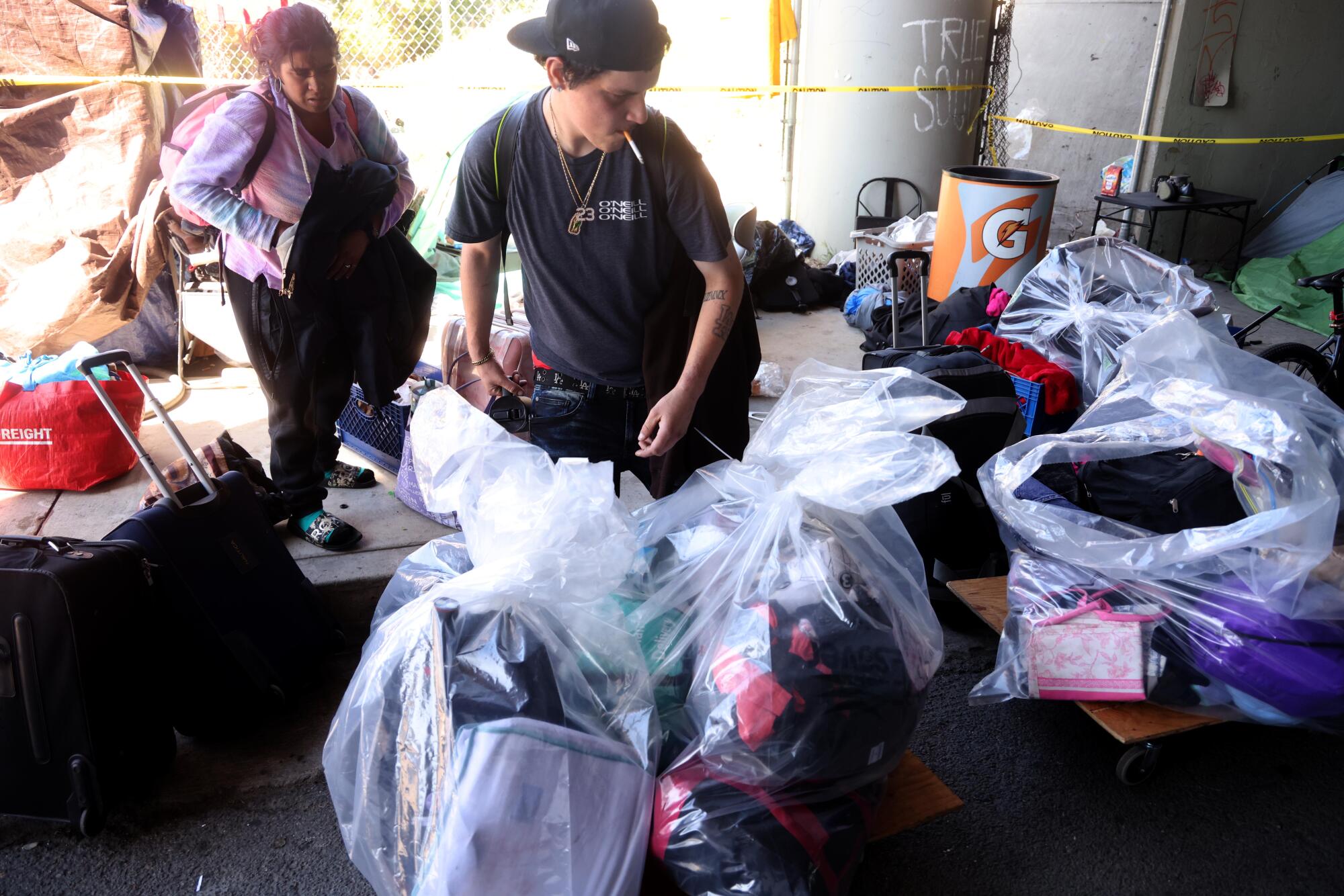 Jeremiah Flores packs up his belongings for interim housing through the Inside Safe Program in North Hollywood. 