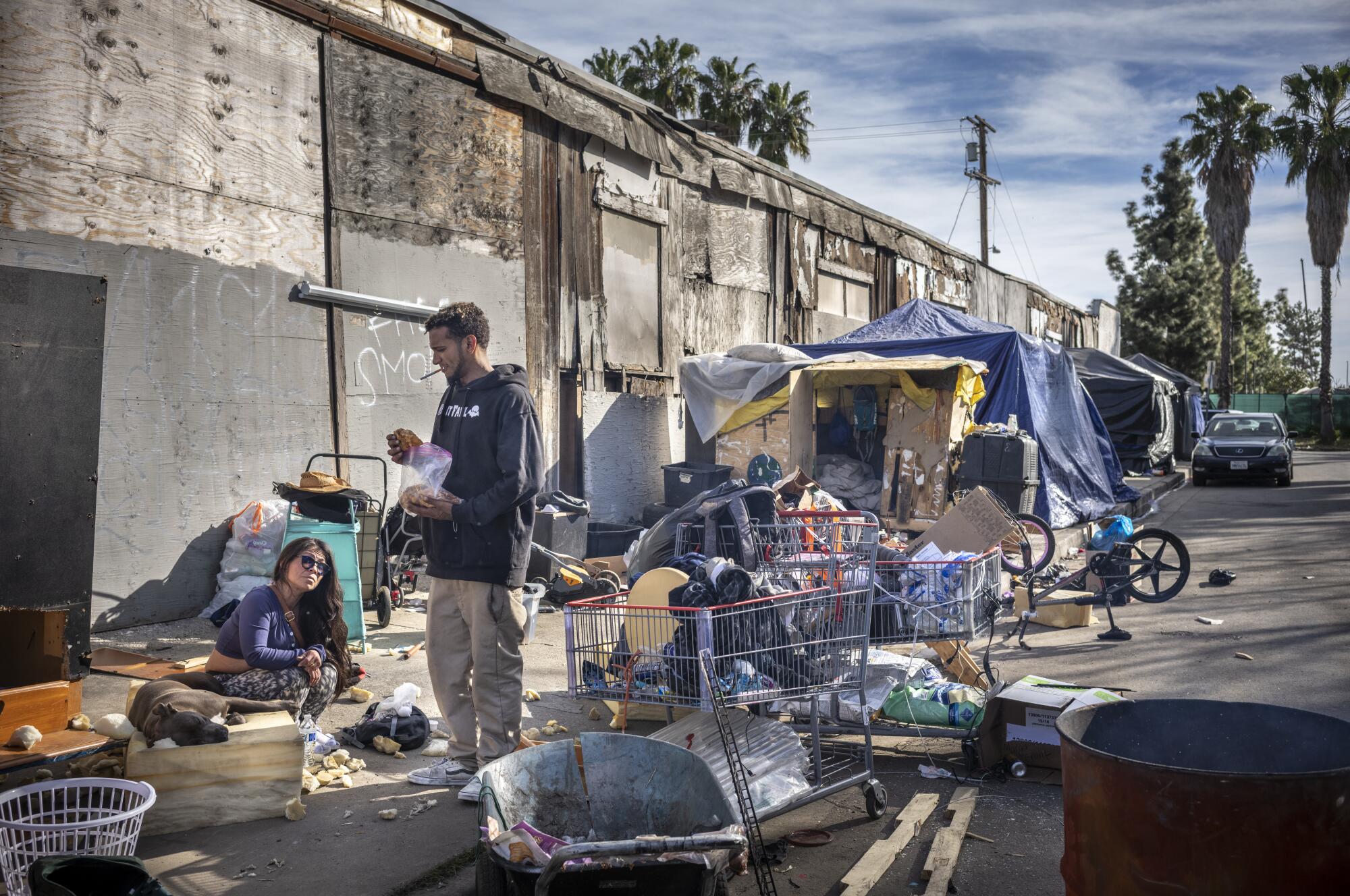 Erica Y. Pena, left and Jose Monteon are pictured at a homeless encampment in Van Nuys.