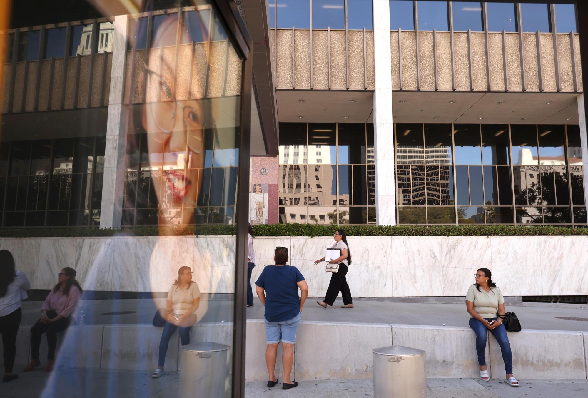 People wait outside the federal building in downtown Los Angeles.