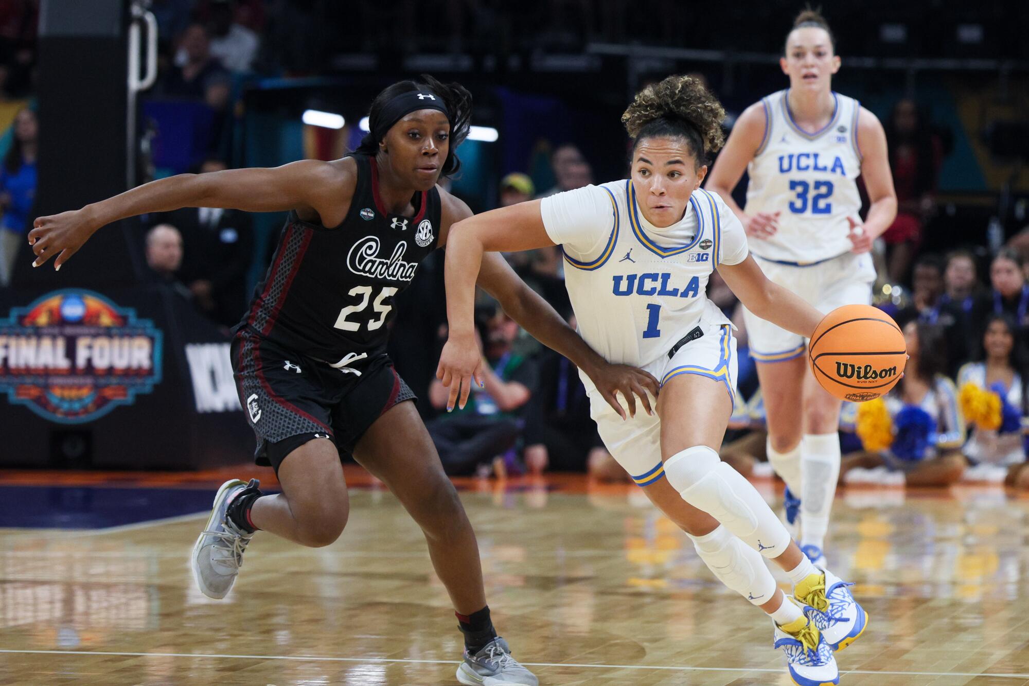 UCLA guard Kiki Rice drives around South Carolina Gamecocks guard Raven Johnson during the NCAA championship game.