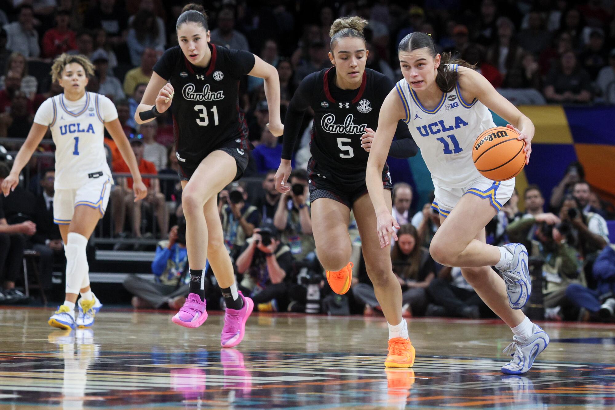 UCLA's Gabriela Jaquez drives ahead of South Carolina's Tessa Johnson.