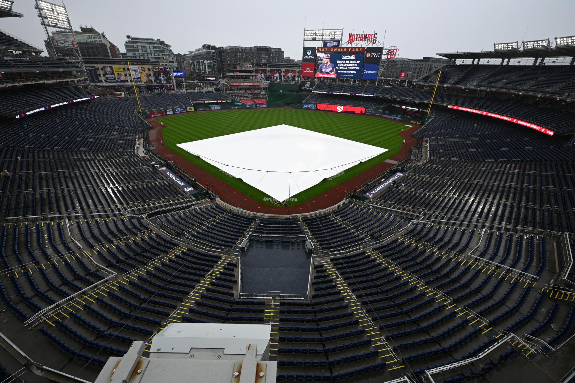 A tarp lies on the field in Washington as rain delays a game between the Dodgers and Nationals on Sunday. 