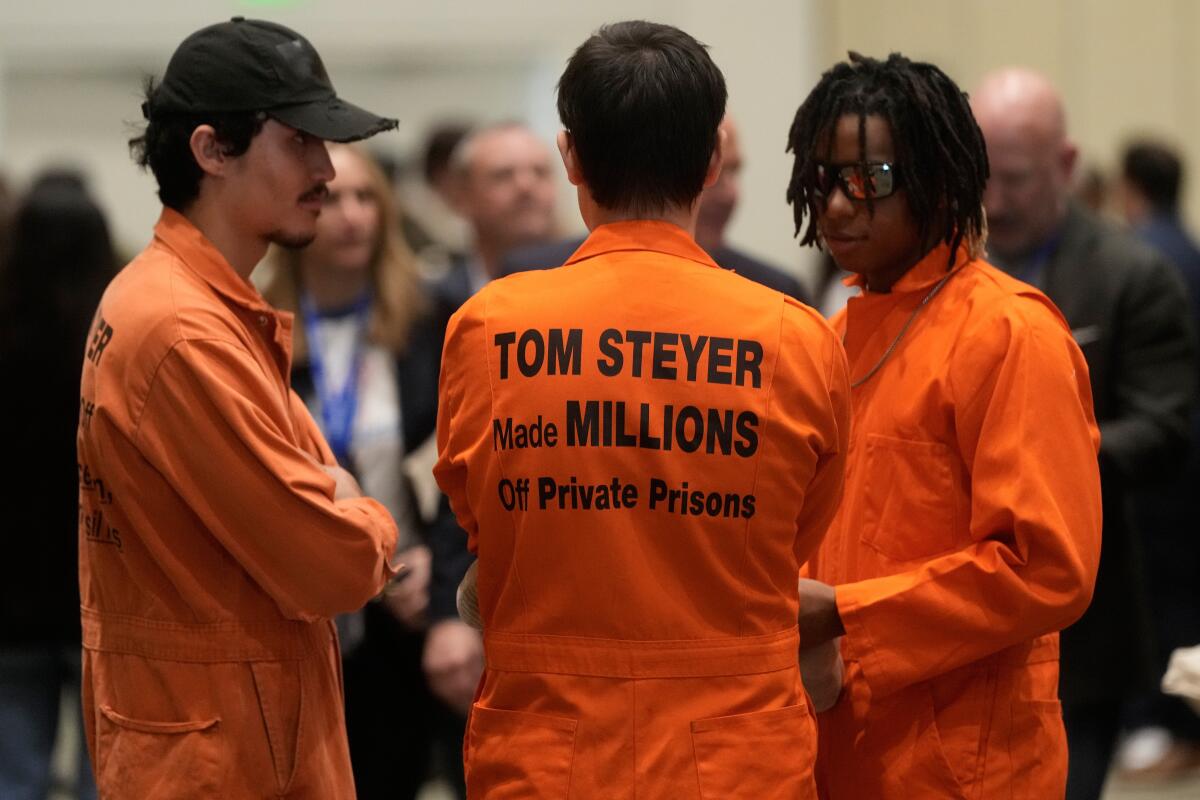 People protest outside of a lunch held by California gubernatorial candidate Tom Steyer