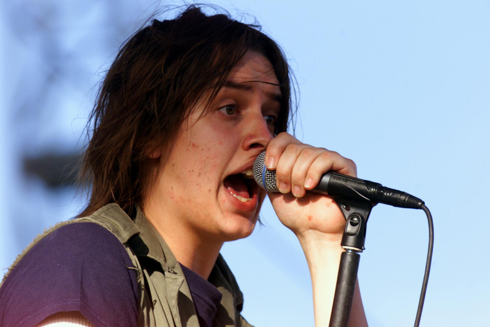 Julian Casablancas sings into a microphone
