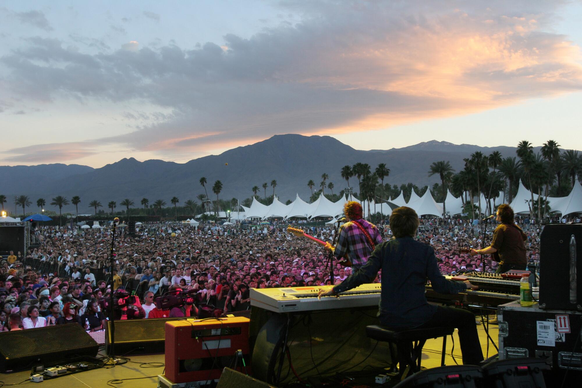 Shot of Wilco from backstage at sunset with thousands of fans watching them at Coachella