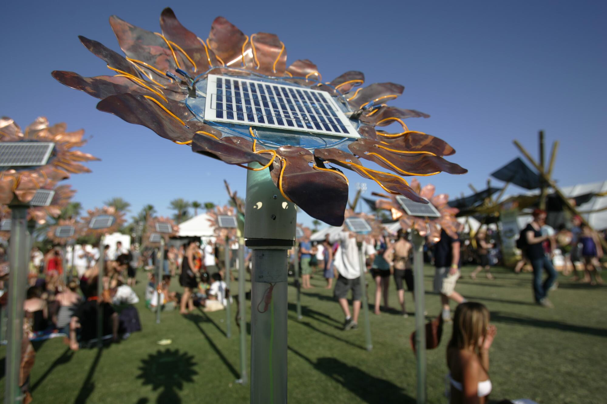 A Field of Sunflower robots with solar panels on a field at Coachella