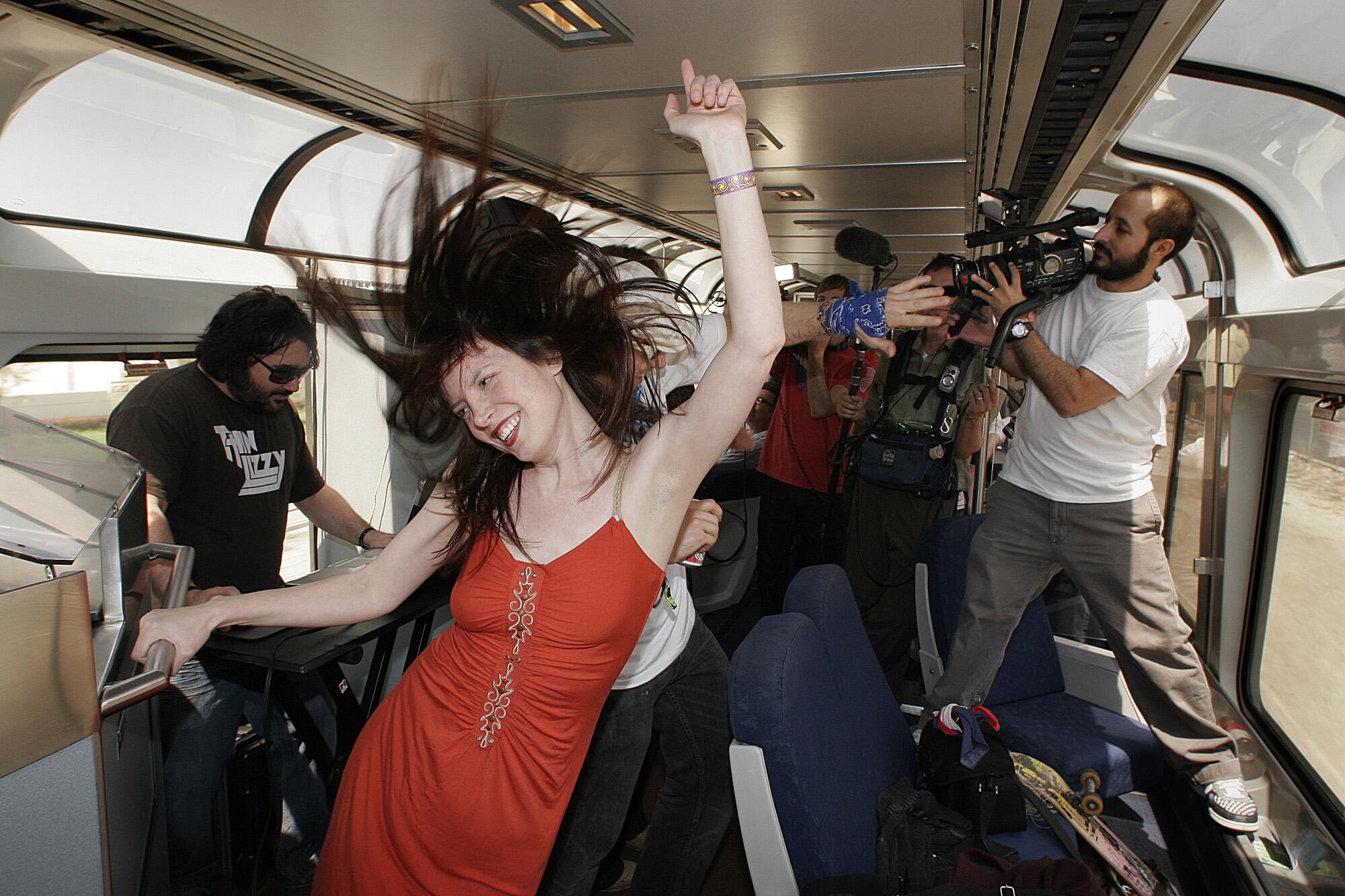 People dance on a train with a live DJ