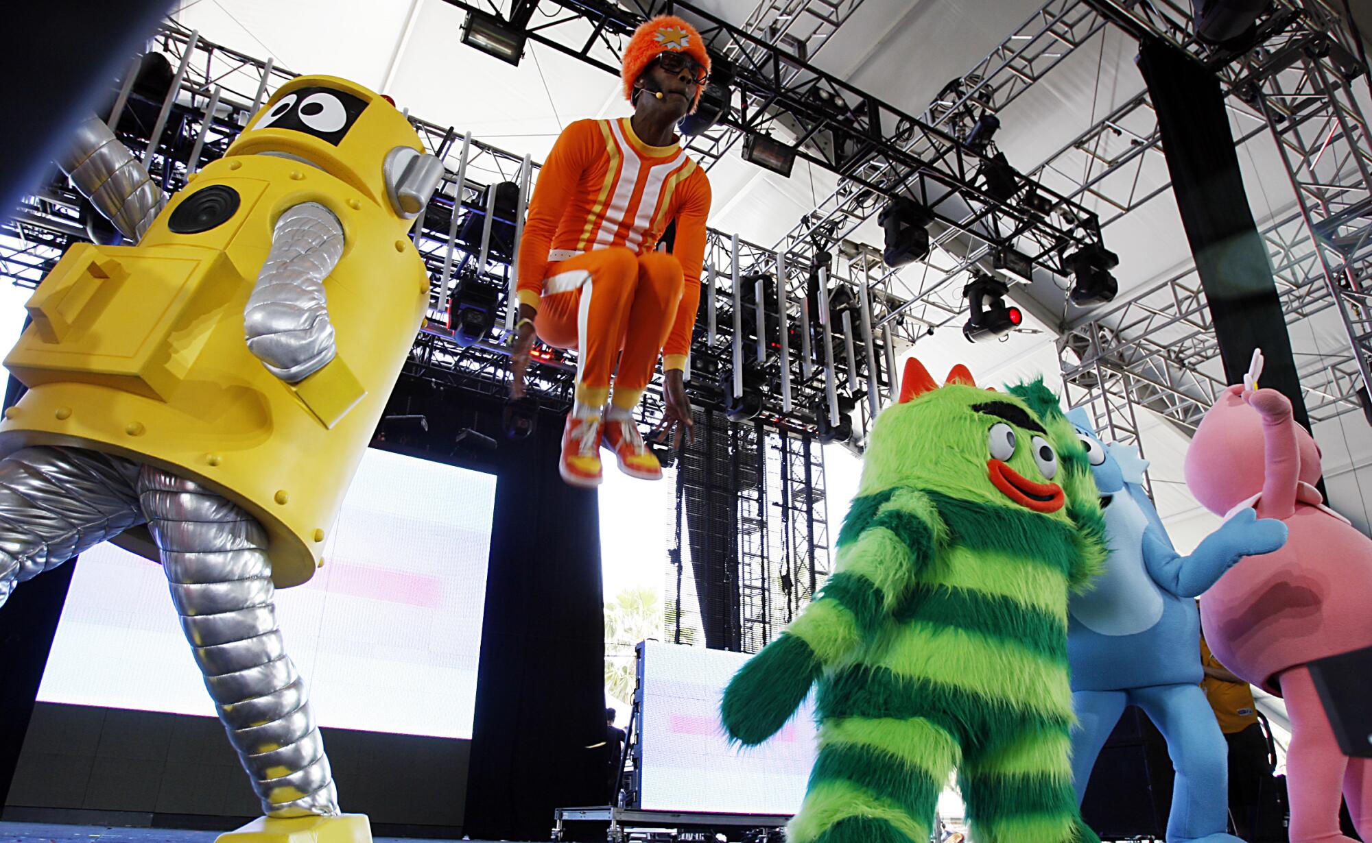 DJ Lance Rock leaps above the Yo Gabba Gabba colorful creatures 