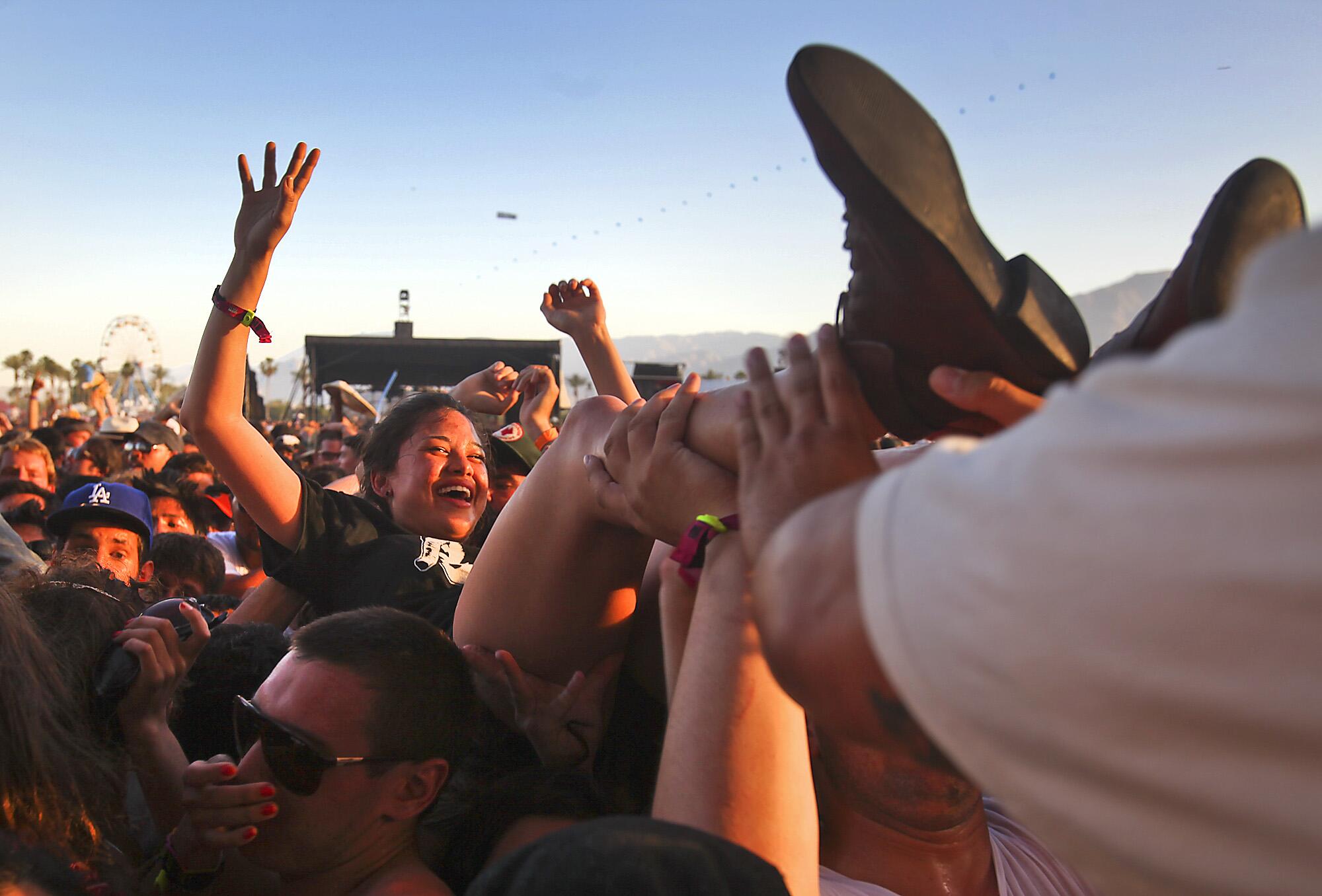 a fan crowd-surfs at Coachella