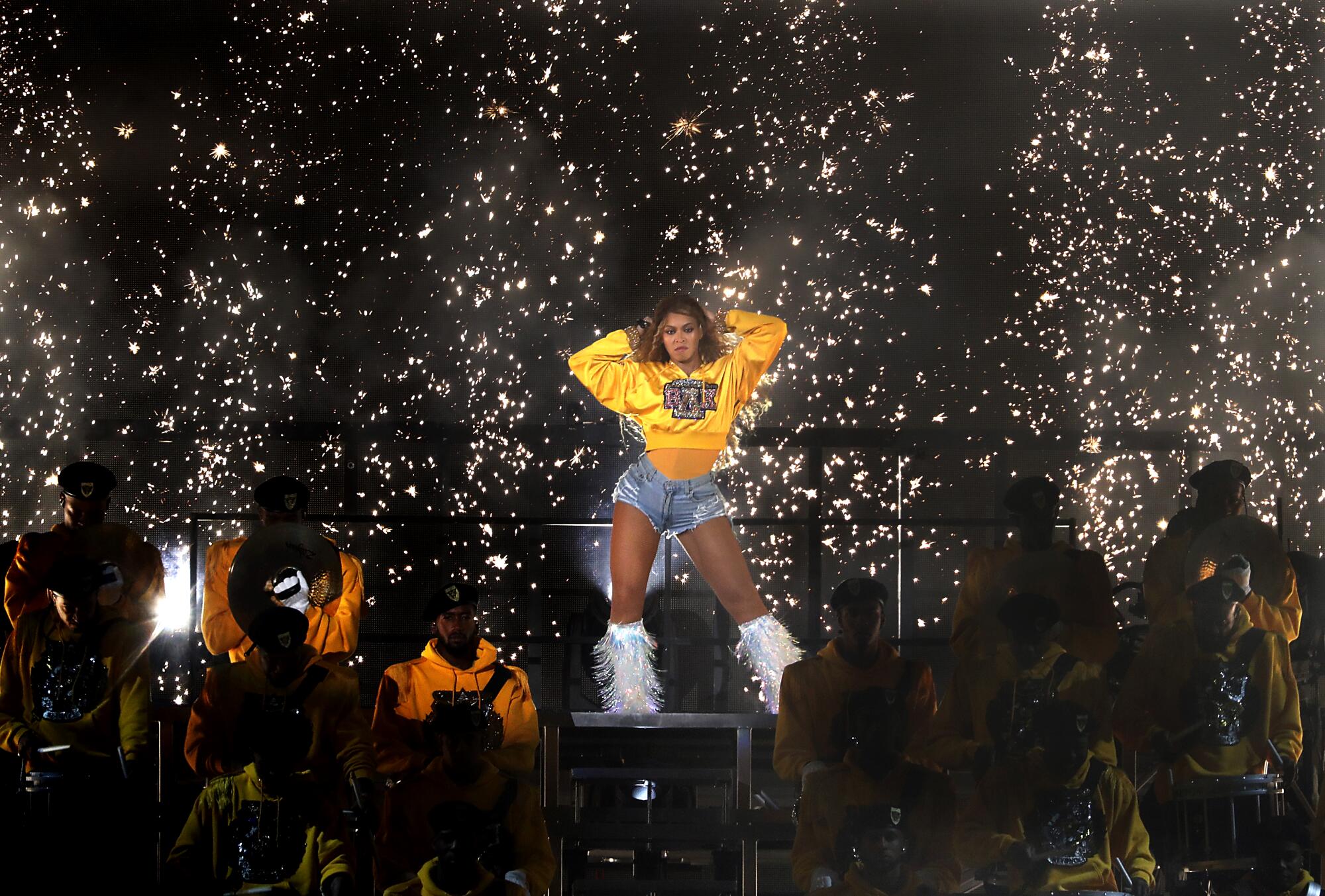 Beyonce performs on stage in front of confetti