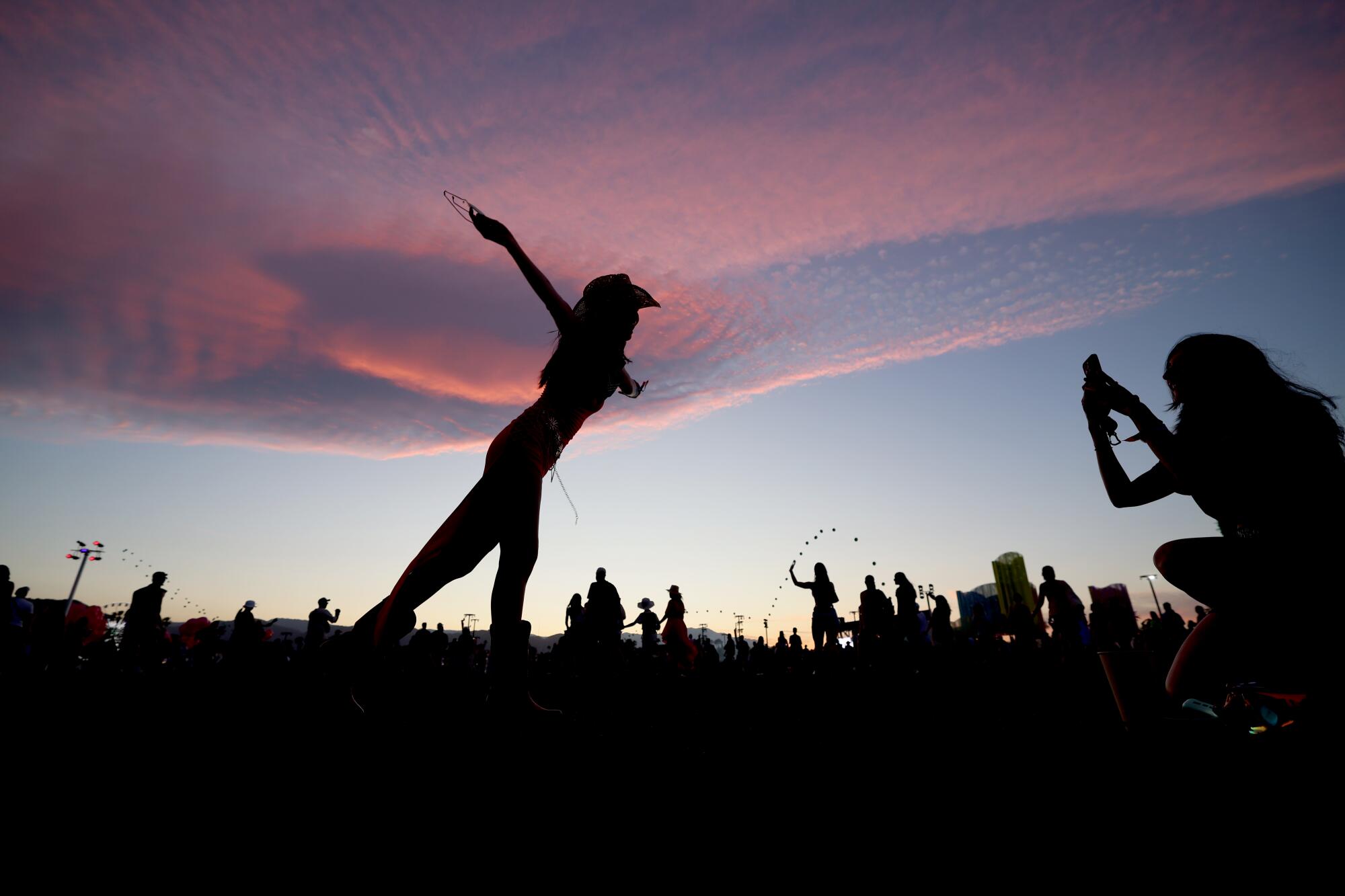 A woman poses for a picture at sunset