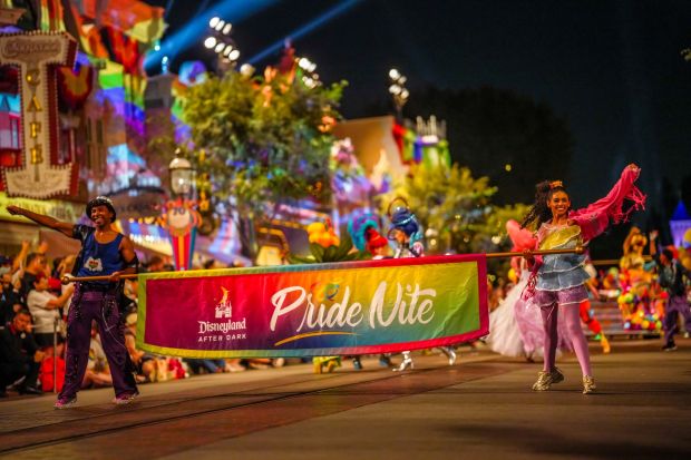 The Welcome Pride cavalcade with Mickey Mouse, Minnie Mouse, Goofy, Donald, Daisy, Pluto and Clarabelle in rainbow outfits during Pride Nite at Disneyland. (Courtesy of Disneyland)