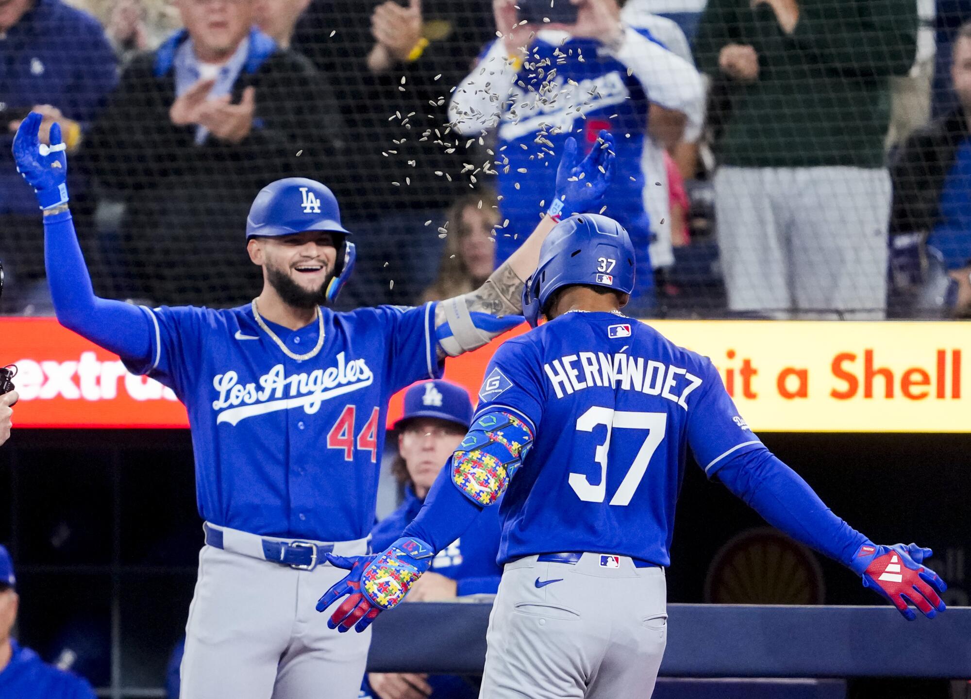 Teoscar Hernández, right, celebrates with Andy Pages after hitting a two-run home run.