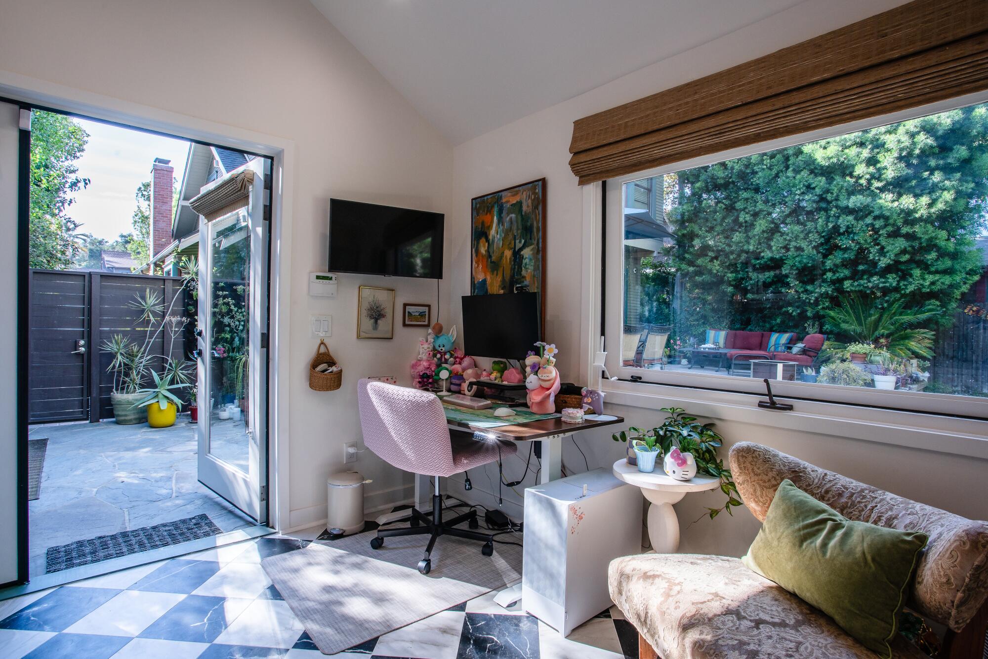 A desk in an ADU overlooking a backyard.