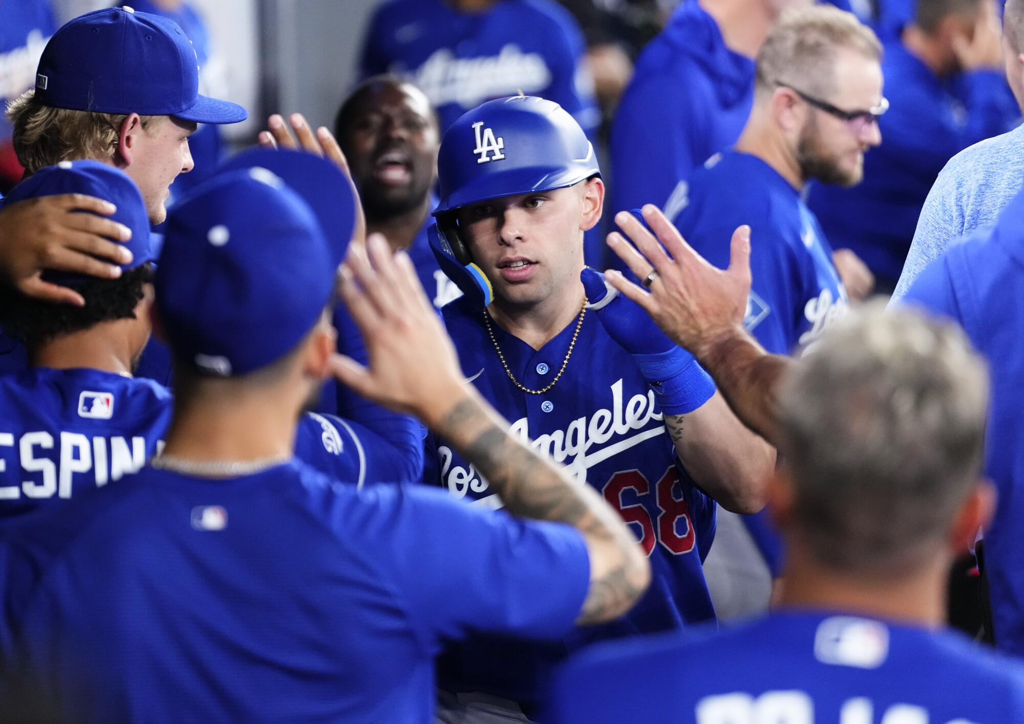 Dalton Rushing celebrates with teammates in the dugout after hitting his second home run of the game against Toronto.