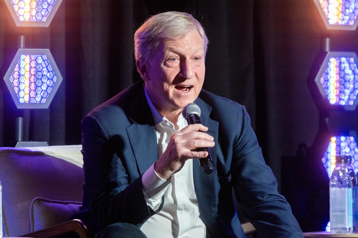 A man speaks into a microphone.