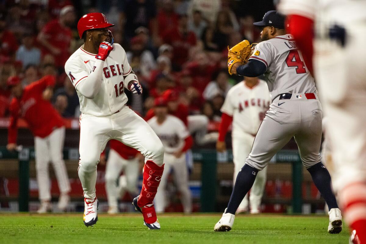 Angels batter Jorge Soler, left, fights Atlanta Braves pitcher Reynaldo López.