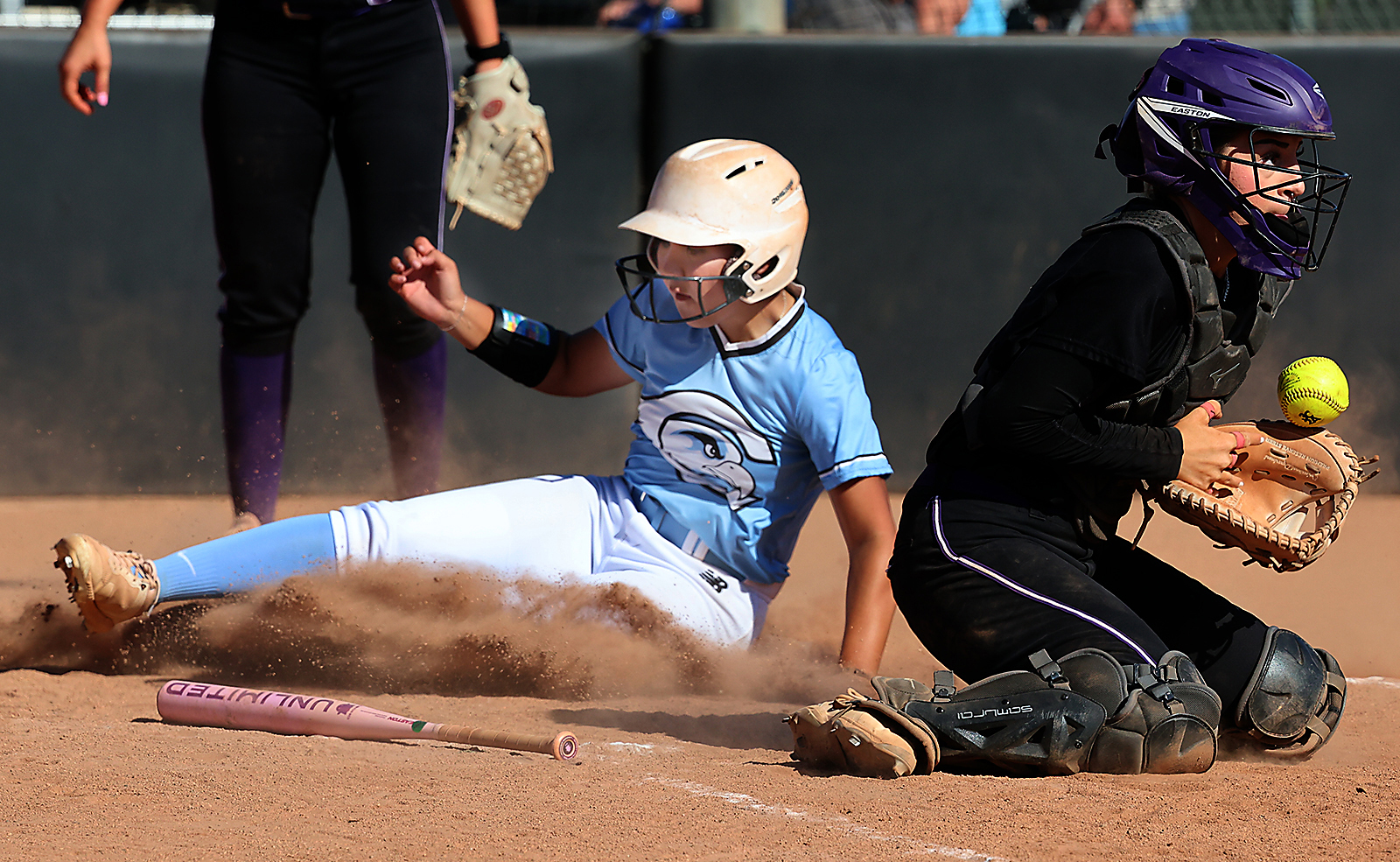 Cabrillo College sophomore Cameron Llamas slides home with a run...