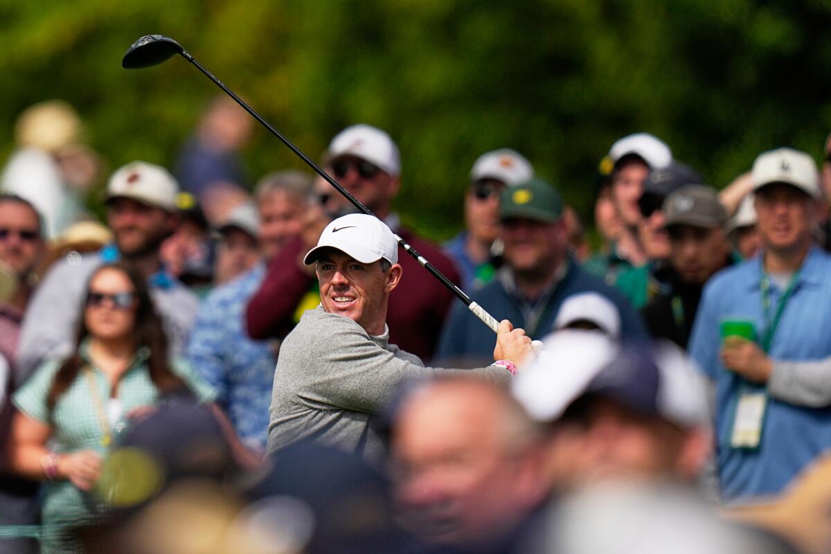 Rory McIlroy watches his tee shot on the 17th hole during a practice round at the Masters.