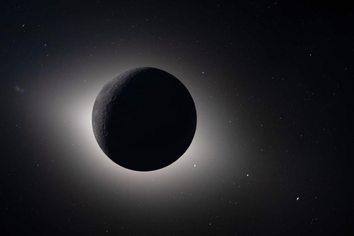 A black circle with light around it.