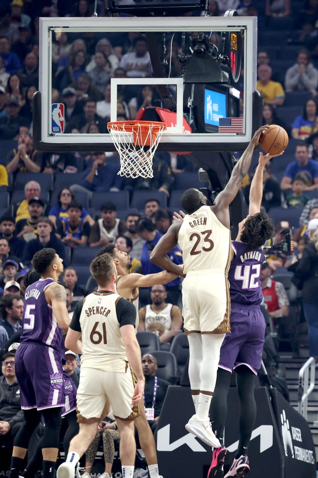 Golden State Warriors' Draymond Green (23) blocks a shot to Sacramento Kings' Maxime Raynaud (42) in the first quarter of an NBA game at Chase Center in San Francisco, Calif., on Tuesday, April 7, 2026. (Ray Chavez/Bay Area News Group)