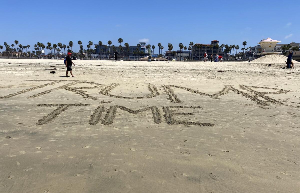 Someone wrote "Trump Time" on the sand at Huntington City Beach