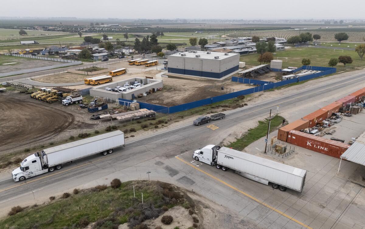 A Roadies Inc. truck, right, leaves for a delivery in Bakersfield.