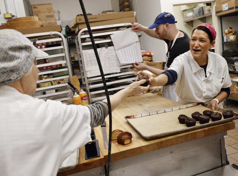 Roxana Jullapat hands out chocolate muffins at Friends & Family in L.A.