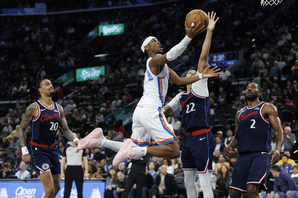 Oklahoma City's Shai Gilgeous-Alexander scores over Clippers guard Jordan Miller in the first half Wednesday.