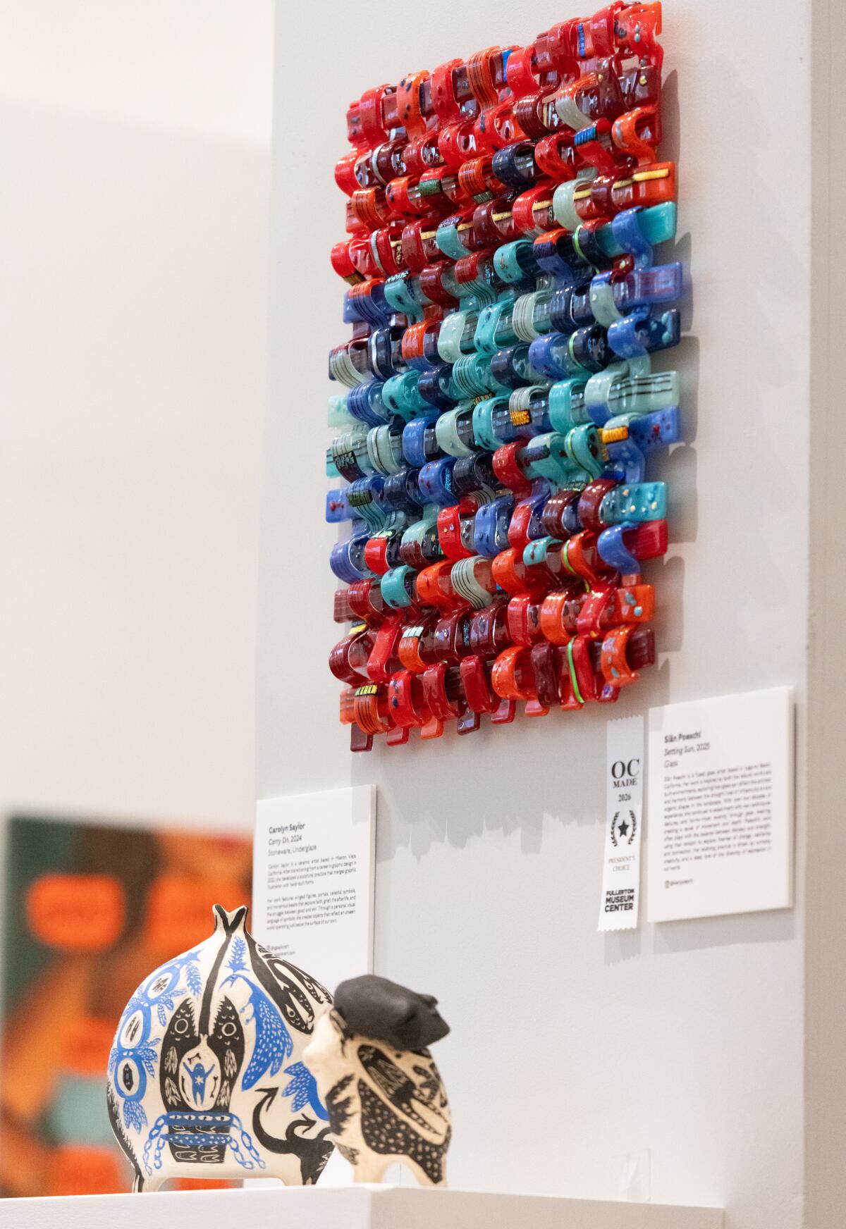 Light reflects off of Siân Poeschi's glass sculpture, "Setting Sun," which won the President's Choice Award at OC Made.