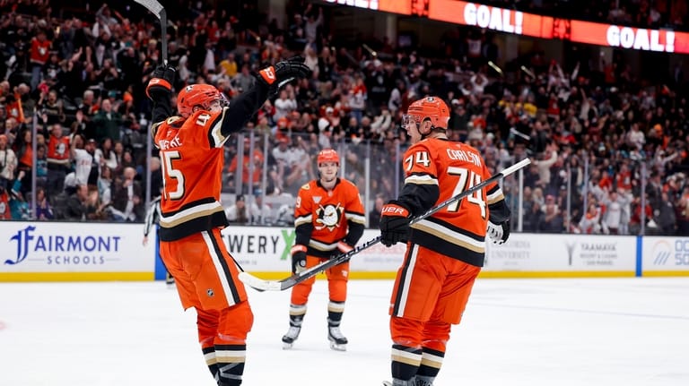 Anaheim Ducks defenseman John Carlson, right, reacts with right wing...