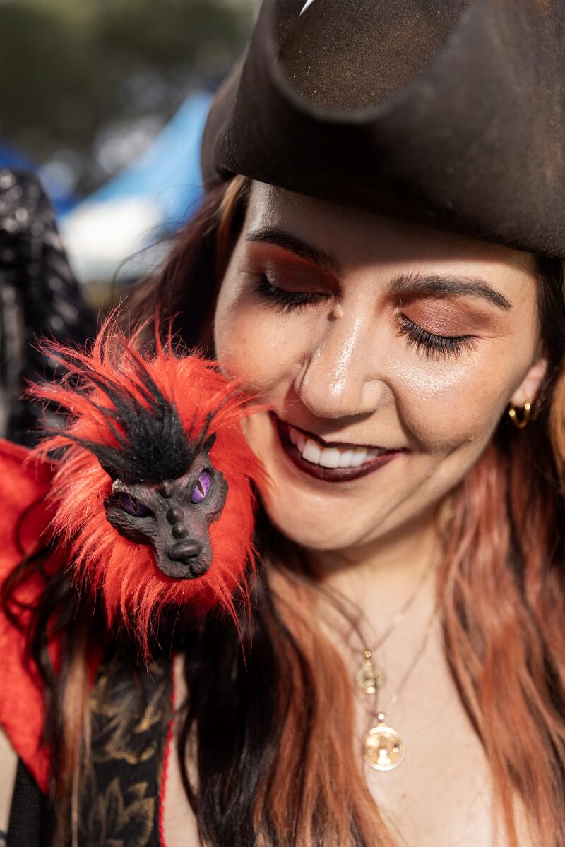 Stephanie Divinski looks down at her shoulder puppet.