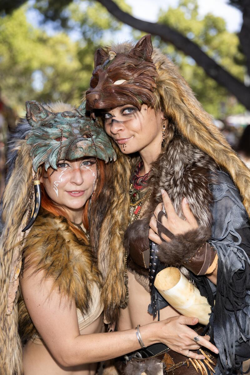 Meisha Mock, left, and Aimey Beer both wear wolf masks created by Meisha.