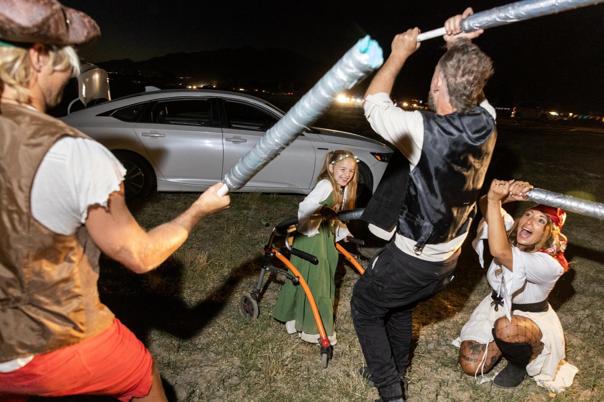 People wave foam swords around as they all wait out traffic after opening day at the Renaissance Pleasure Faire.