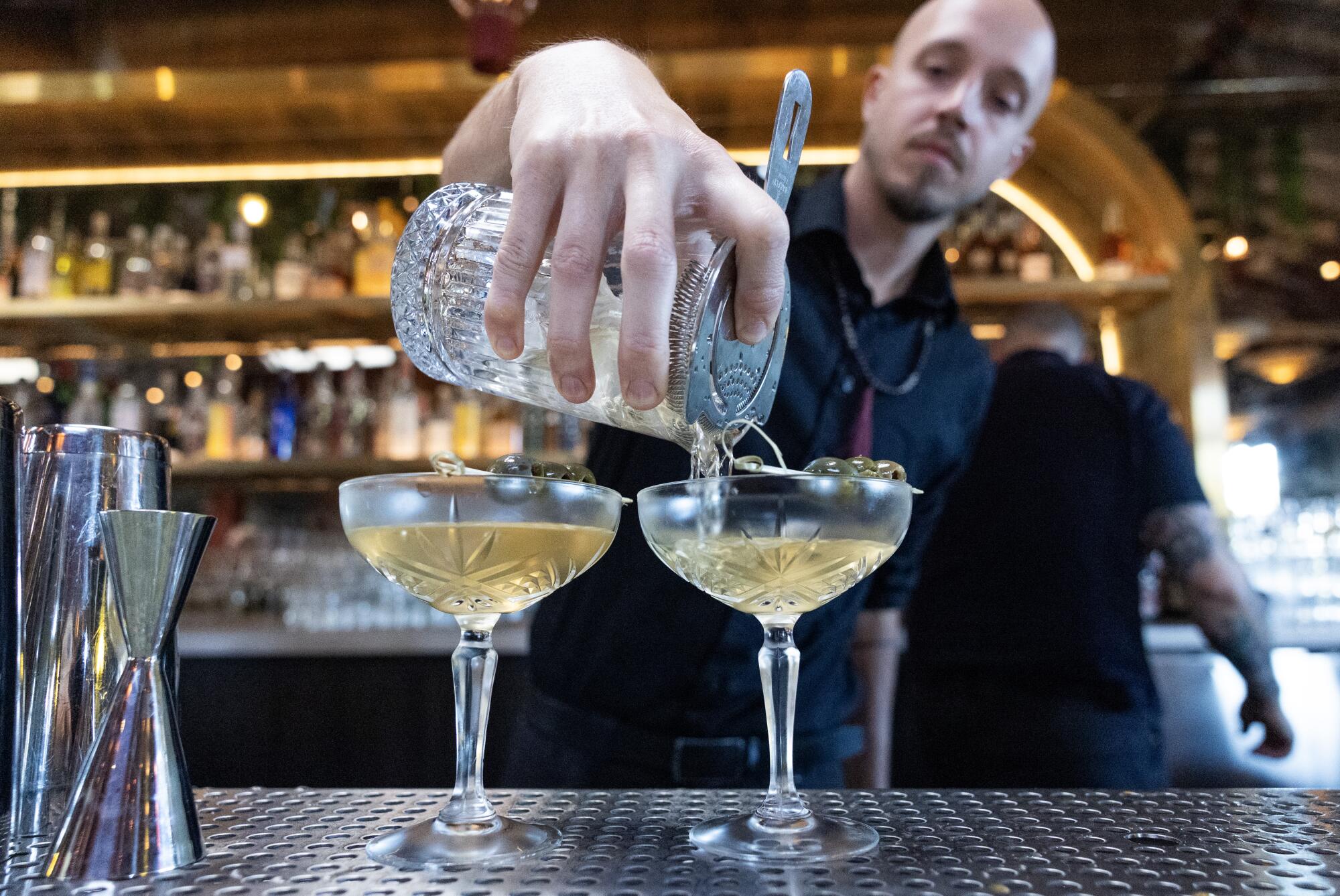Bartender Zac Hills-Bonczyk pours Za'atar martinis at the Maydan Restaurant bar