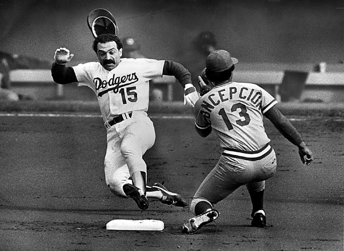 Davey Lopes steals second while Reds shortstop Davey Concepcion awaits the throw in a 1980 game.