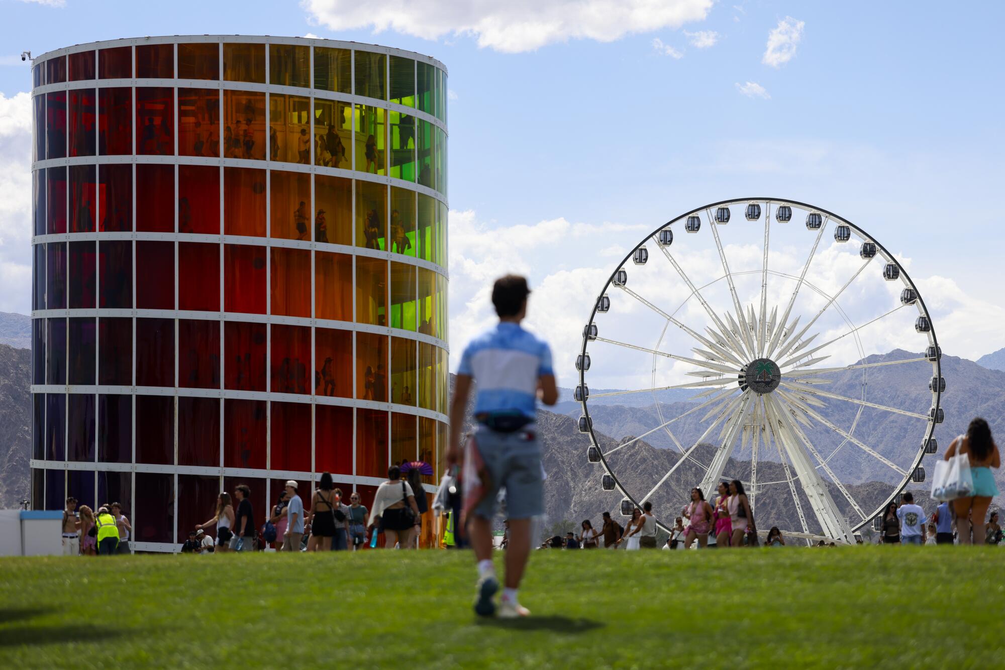 Festival goers walk near the SPECTRA and Ferris Wheel.