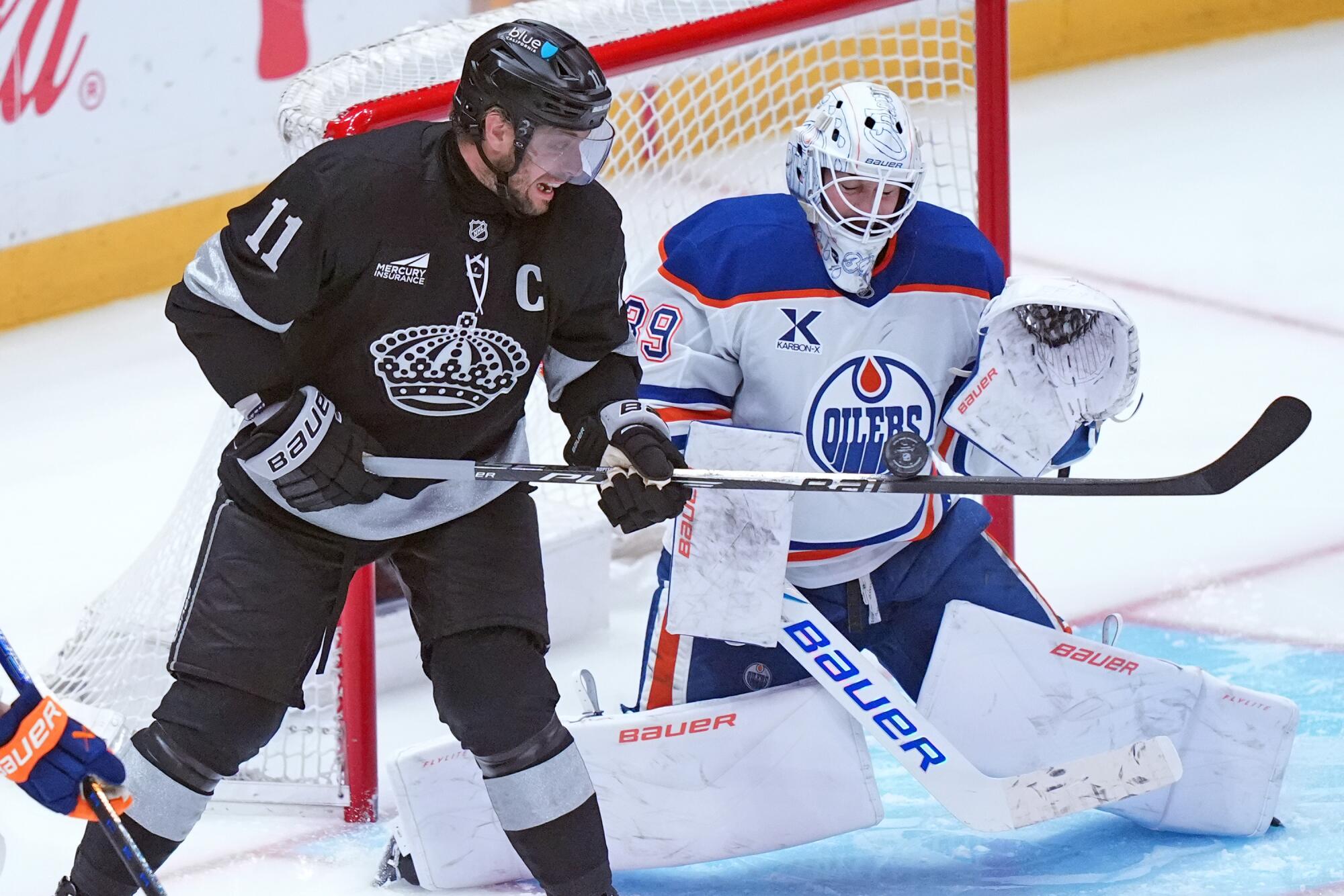 The Kings' Anze Kopitar tries to flip a shot past Edmonton goaltender Connor Ingram Saturday at Crypto.com Arena.