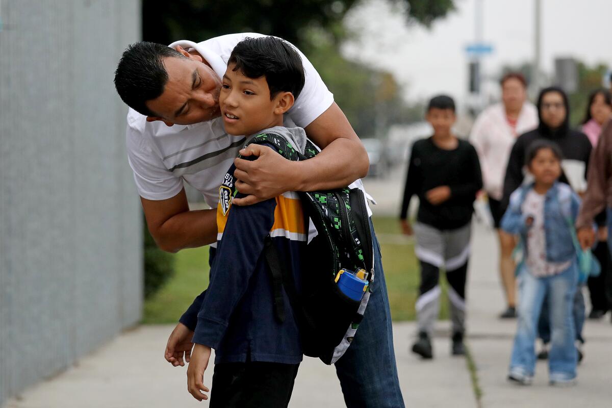 A man drops off his son at Parmelee Avenue Elementary School.