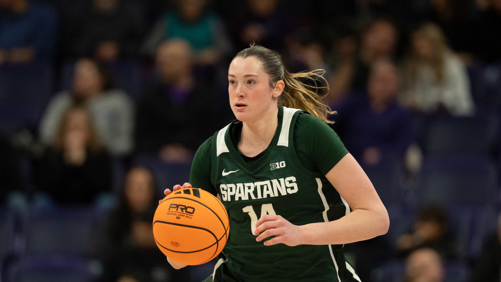 Michigan State forward Grace VanSlooten dribbles the ball during a game against Washington on Jan. 8.