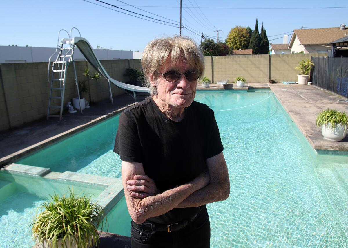 Frank Clarke, 81, of Huntington Beach, is worried that the O.C. Sanitation District will demolish his pool on Rhone Lane.
